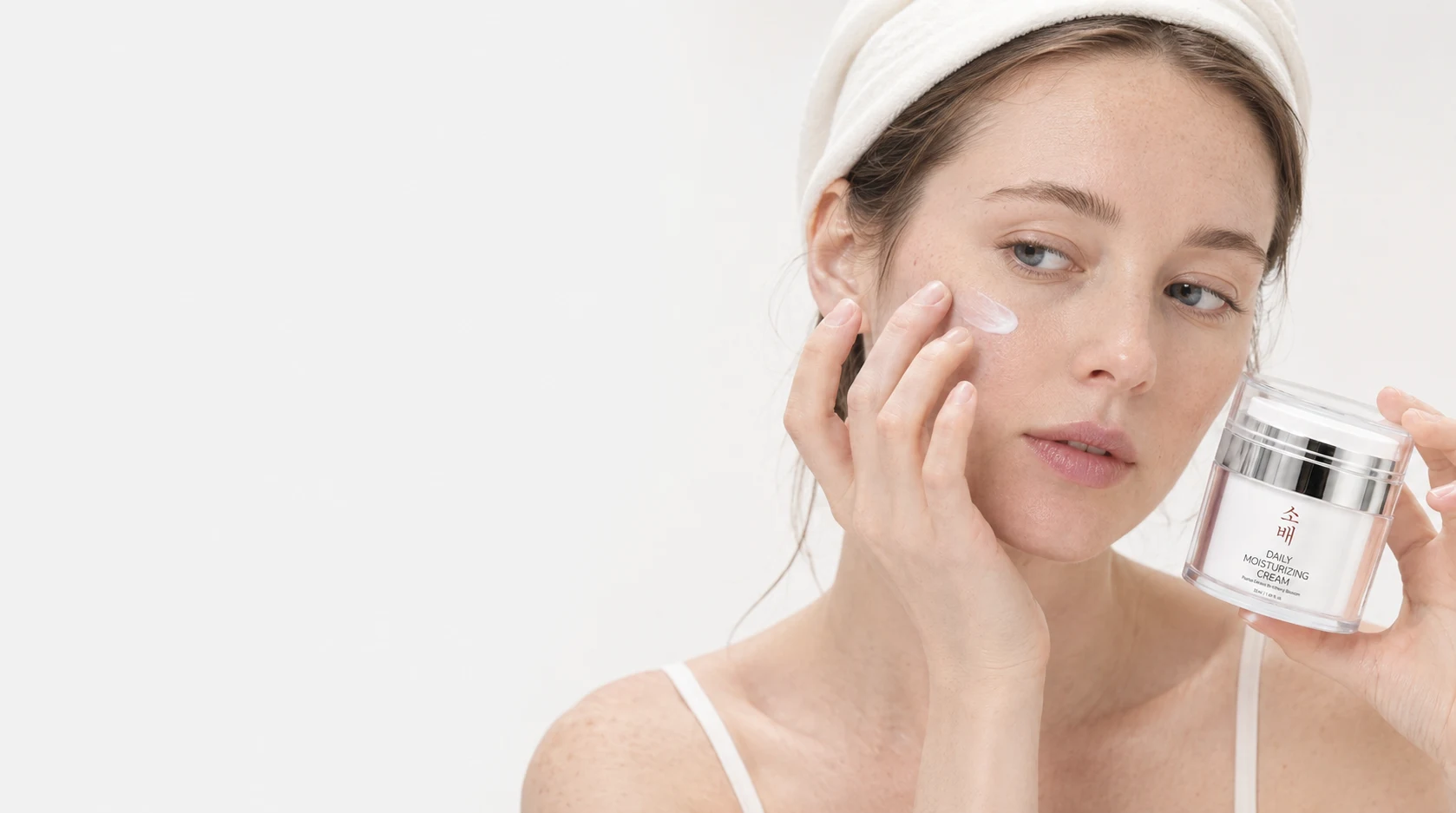 Model applying SOBAE Daily Moisturizing Cream